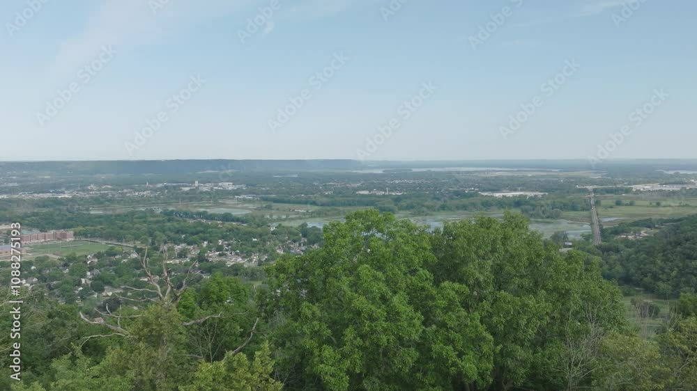 Tilt up drone shot of Grandad Bluff overlooking the city of La Crosse, the Mississippi River Valley, Wisconsin in USA. Famous symbol of the great Driftless Region. Tilt up drone shot of Grandad Bluff overlooking the city of La Crosse, the Mississippi River Valley, Wisconsin in USA. Famous symbol of the great Driftless Region.