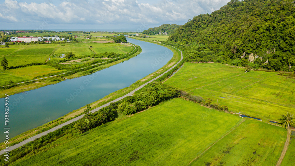 Panoramic aerial drone view of green paddy crops with waterway canal at Kampung Wai, Perlis, Malaysia Panoramic aerial drone view of green paddy crops with waterway canal at Kampung Wai, Perlis, Malaysia
