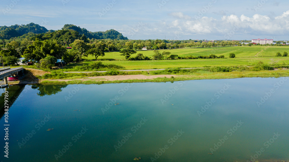 Panoramic aerial drone view of green paddy crops with waterway canal at Kampung Wai, Perlis, Malaysia Panoramic aerial drone view of green paddy crops with waterway canal at Kampung Wai, Perlis, Malaysia