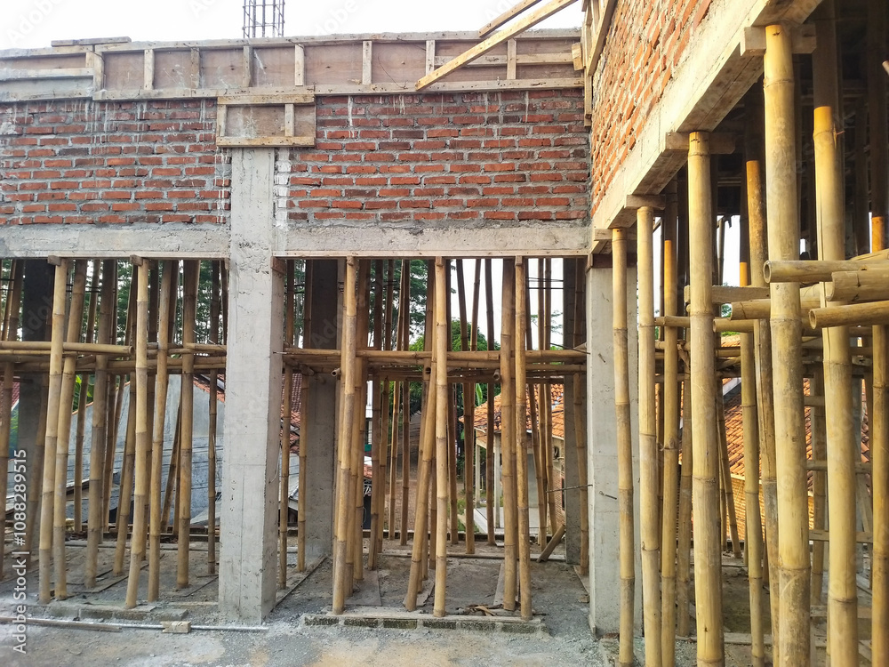 Obraz premium Construction site using bamboo scaffolding for traditional structural support and sustainable building practices