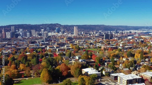  aerial view of downtown Portland, Oregon, showcasing its iconic skyline and vibrant neighborhoods adorned with fall foliage.