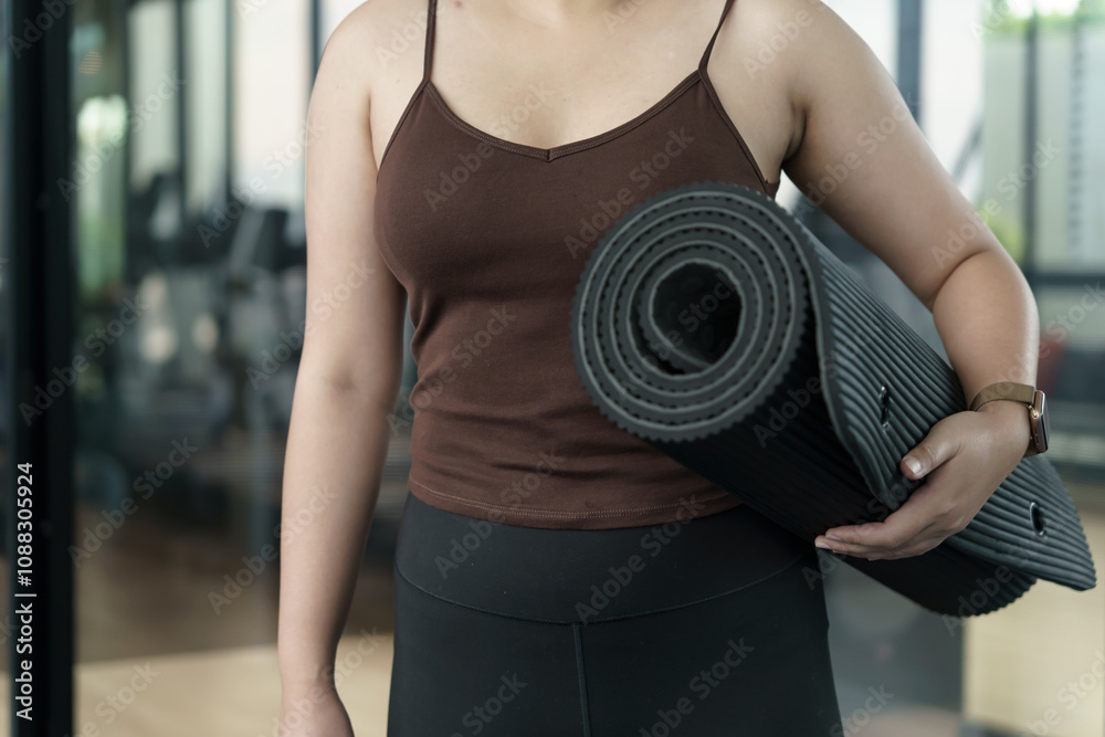 Sporty woman holding yoga mat for training yoga exercising fitness workout and health concept. training working out at gym. Sporty woman holding yoga mat for training yoga exercising fitness workout and health concept. training working out at gym.