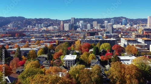  aerial view of downtown Portland, Oregon, showcasing its iconic skyline and vibrant neighborhoods adorned with fall foliage.