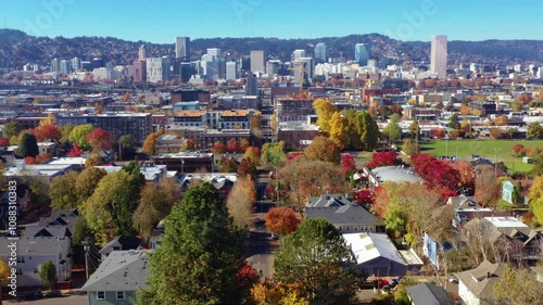  aerial view of downtown Portland, Oregon, showcasing its iconic skyline and vibrant neighborhoods adorned with fall foliage.