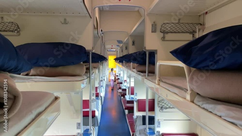 A little girl runs along an empty reserved seat carriage. A budget trip with the whole family. High quality 4k footage