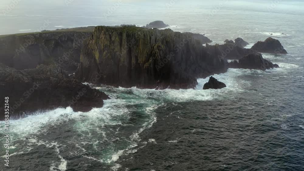 Wide aerial orbit of Hell's Hole at Malin Head, showcasing rugged coastline Wide aerial orbit of Hell's Hole at Malin Head, showcasing rugged coastline