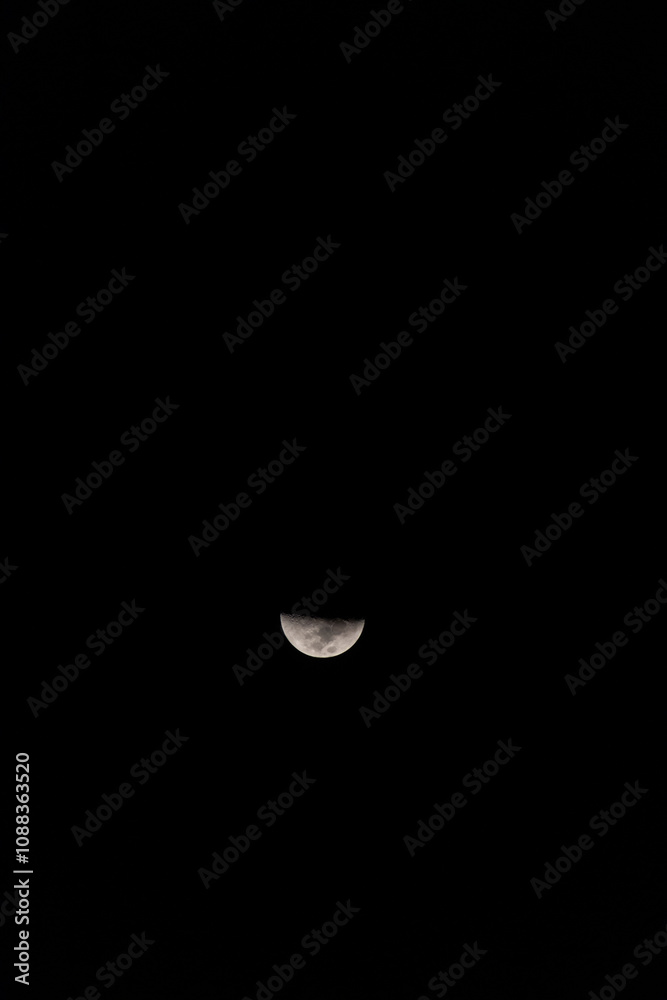 A stunning view of a crescent moon against a dark backdrop, showcasing its detailed surface and enchanting glow. A stunning view of a crescent moon against a dark backdrop, showcasing its detailed surface and enchanting glow.