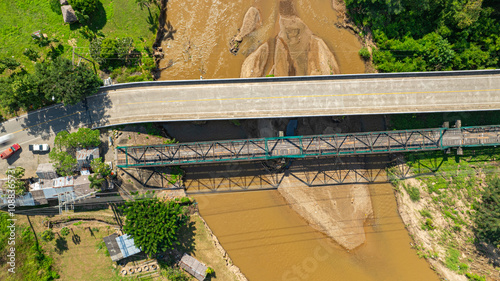 Aerial view of The Ta Pai Memorial Bridge is like the gateway to Pai. It is a bridge with a dark green steel frame and wooden floor spanning the Pai River. It was built during World War II. photo