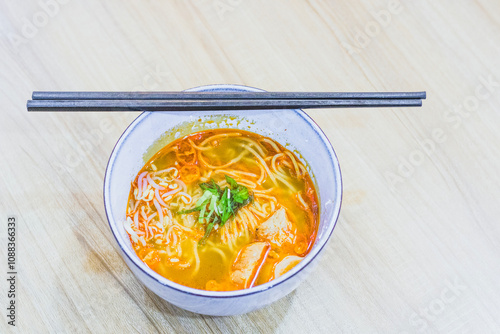 Ramen with chopsticks on the table, Japanese style noodle soup, Chuka soba or shina soba photo