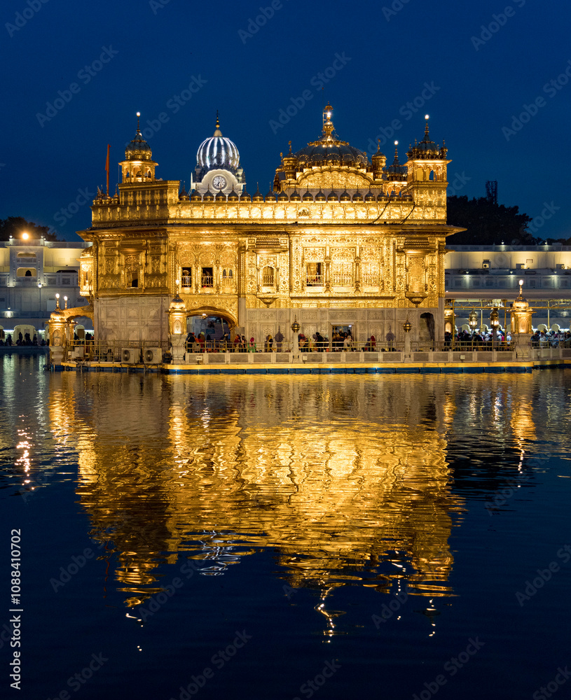 The golden temple in amritsar, india, reflects beautifully on the serene water at dusk The golden temple in amritsar, india, reflects beautifully on the serene water at dusk
