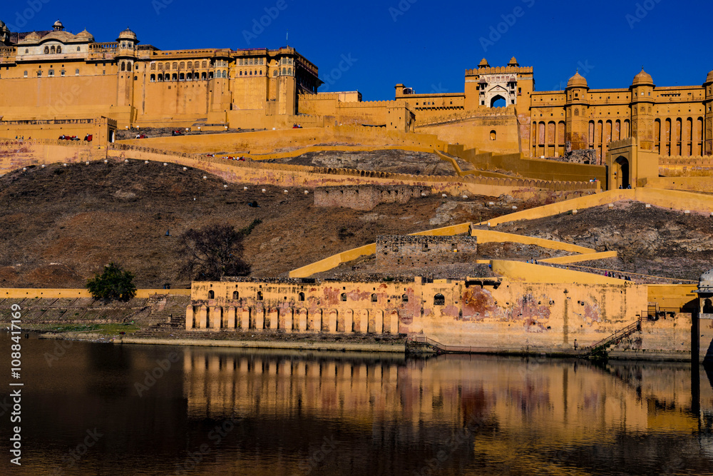 Fototapeta premium Scenic view of amber fort reflecting in water against a clear blue sky in jaipur, india