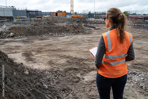 A female construction manager visiting a new project site. Shes assessing the site conditions and planning initial steps
