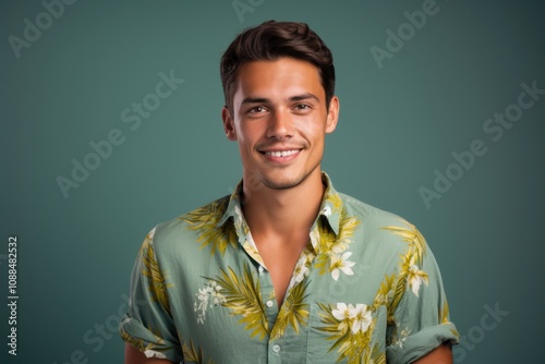 A man with a green shirt and a smile on his face