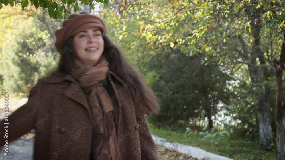 Mid shot of young happy Caucasian woman wearing vintage clothes is dancing merrily in the park. Concept of happiness, psychology and positive emotion Mid shot of young happy Caucasian woman wearing vintage clothes is dancing merrily in the park. Concept of happiness, psychology and positive emotion