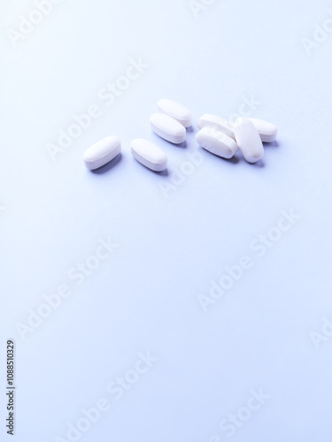 Amino acids tablets. Nutrition for bodybuilding. Fitness supplements on bright background. Soft focus. Copy space. 