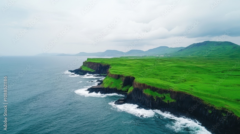 Stunning Aerial View of Lush Green Cliffs Overlooking Calm Ocean Waves with Dramatic Clouds in the Sky on a Peaceful Day Stunning Aerial View of Lush Green Cliffs Overlooking Calm Ocean Waves with Dramatic Clouds in the Sky on a Peaceful Day