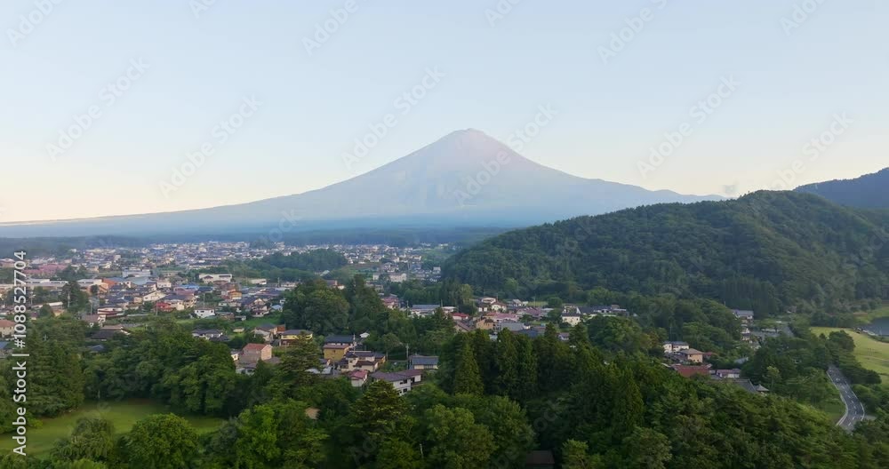 Aerial view rising toward the Fujikawaguchiko town and Mt Fuji, sunrise in Japan