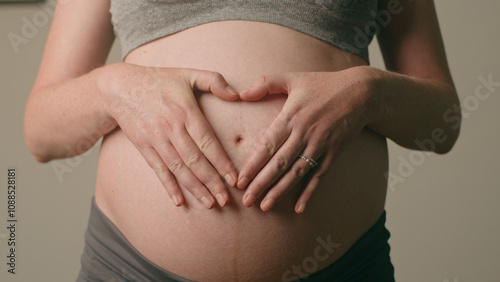 Wallpaper Mural Heartfelt Connection: Expecting Mother Gently Embracing Her Pregnant Belly Torontodigital.ca