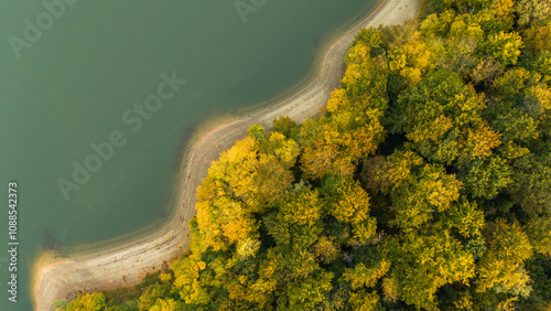 Fototapeta Naklejka Na Ścianę i Meble -  Autumn Serenity: Aerial View of Solina Lake and Bieszczady's Fall Landscape