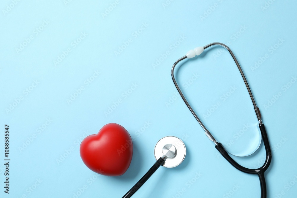 Stethoscope with red heart on color background, top view Stethoscope with red heart on color background, top view