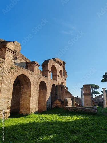 Ostia Antica, Rome, Italy - November 3, 2024. Remains of a brick building with arches dating back to the Roman Empire, in the Archaeological Park of Ostia Antica.