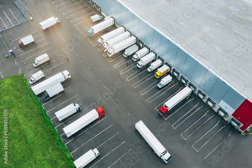 Aerial view of many trucks at the loading docks of a large distribution warehouse. photo