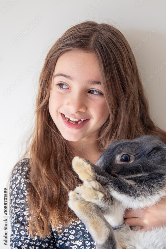 A girl with a rabbit. The girl holds a rabbit in her arms.. A girl with a rabbit. The girl holds a rabbit in her arms..