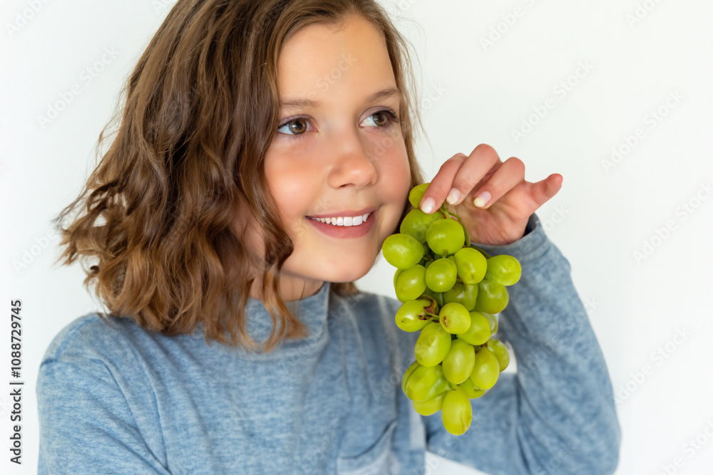 Girl is putting grapes on white . grape fruit beautiful concept. girl with bunch of grapes in her hand on a white . a girl standing with a bunch of green grapes in her hand lifestyle on a white. Girl is putting grapes on white . grape fruit beautiful concept. girl with bunch of grapes in her hand on a white . a girl standing with a bunch of green grapes in her hand lifestyle on a white.
