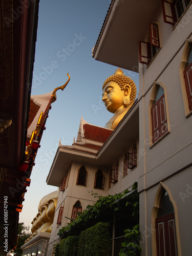 The Iconic Big Buddha Statue in Bangkok, Thailand at Sunset, Wat Paknam Phasi Charoen photo