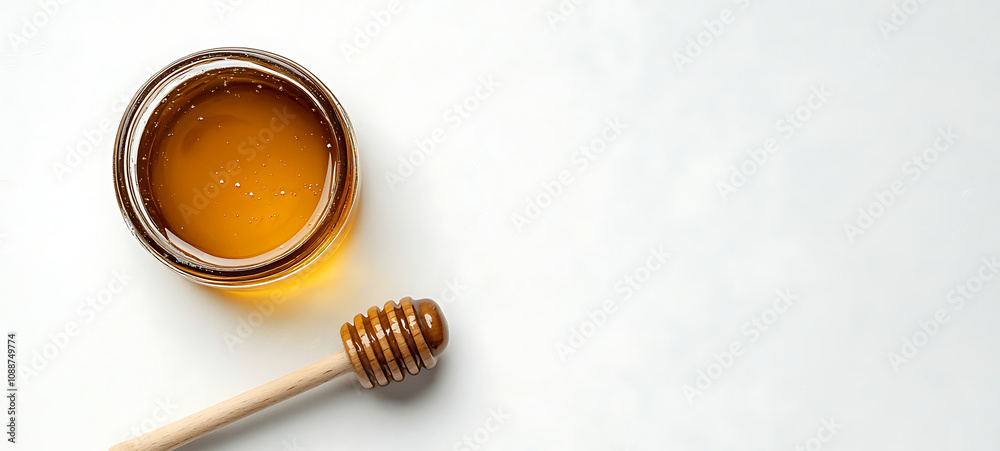 Top view of a honey jar with a wooden honey dipper on a white background with copy space. created with Generative AI technology Top view of a honey jar with a wooden honey dipper on a white background with copy space. created with Generative AI technology