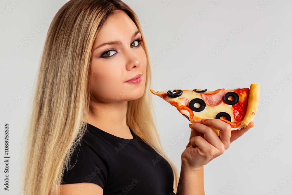 Girl in gray with pizza on the . food female person concept. girl holding slice of pizza in her hand on a gray . a girl in gray holding a slice of pizza in her hand on a white lifestyle. Girl in gray with pizza on the . food female person concept. girl holding slice of pizza in her hand on a gray . a girl in gray holding a slice of pizza in her hand on a white lifestyle.