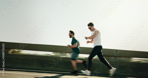 Foto Men, runner and together for fitness in city on bridge for training, challenge and motion blur with speed on road
