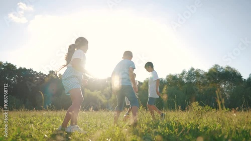 children playing ball in the park. a group of children playing ball at sunset in nature. happy family kid dream concept. children lifestyle playing soccer in the park in nature