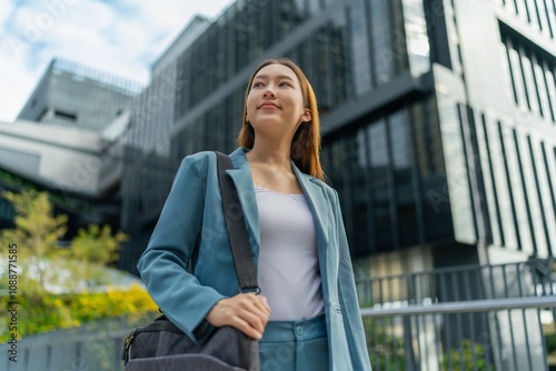 Portrait of a young and confident businesswoman standing in front a modern office building in the financial district