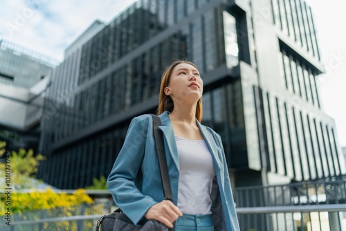 Portrait of a young and confident businesswoman standing in front a modern office building in the financial district