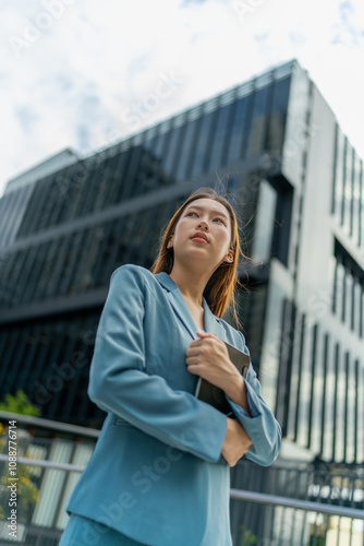 Young Businesswoman Using Digital Tablet In Front A Modern Office Building in a Financial District Free Download Young Businesswoman Using Digital Tablet In Front A Modern Office Building in a Financial District - GFXLoad