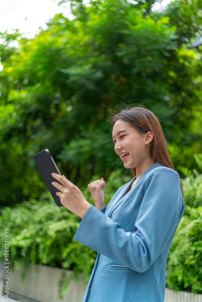 Asian Businesswoman Using Digital Tablet Amid Greenery in A Park Asian Businesswoman Using Digital Tablet Amid Greenery in A Park
