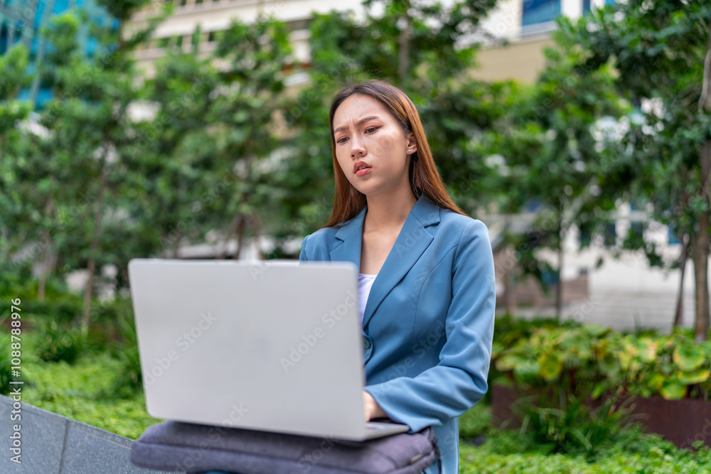 Young Businesswoman Using Laptop In Front A Modern Office Building Young Businesswoman Using Laptop In Front A Modern Office Building