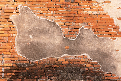 Brick Wall with Partially Peeling Plaster.