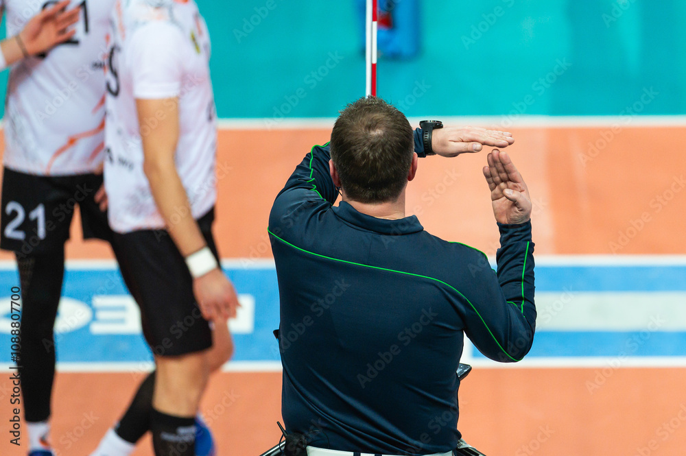 The referee gives a sign with his hand during a volleyball match.
