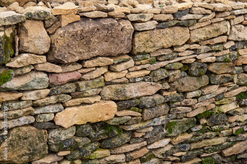 Un mur extérieur constitué en pierres de taille de différentes tailles et couleurs photo