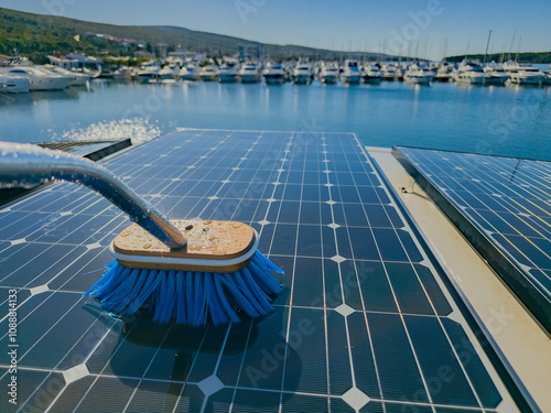 Fotografia Photography of solar panels on a boat docked at the port being cleaned up with a blue brush and water to collect solar energy more efficiently during a sunny day
