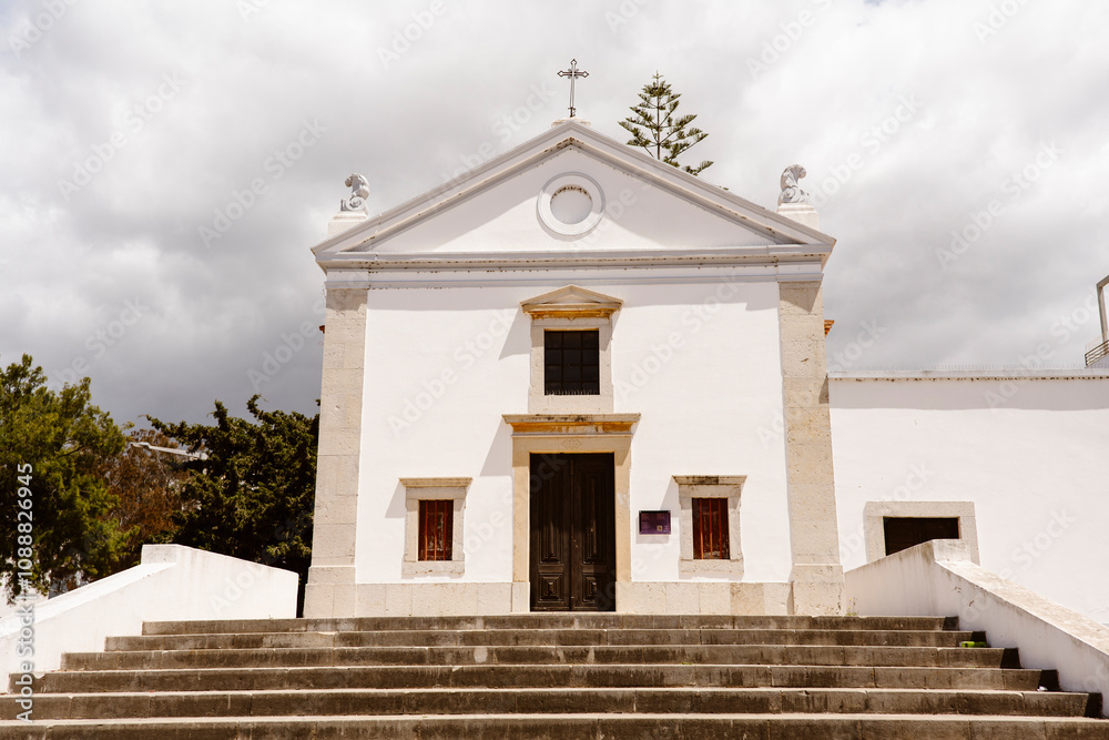 Small Chapel with cloudy sky in the background - Albufeira, Portugal Small Chapel with cloudy sky in the background - Albufeira, Portugal