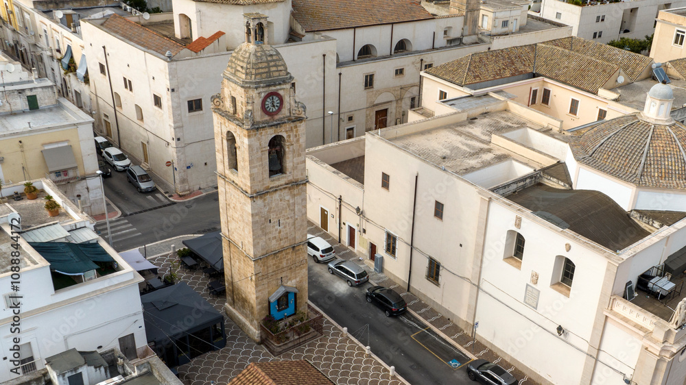 Fototapeta premium Aerial view of the Orsini bell tower located in the historic center of Manfredonia, in the province of Foggia, Puglia, Italy.