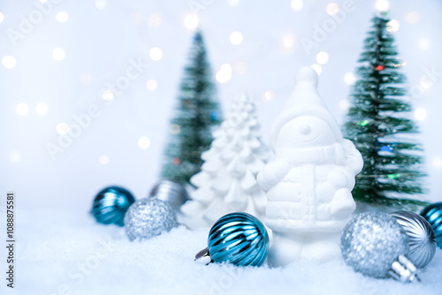 Christmas card. Plaster toys in the form of a Christmas tree and a gnome on a snowy background. DIY gifts. Close-up. Selective focus.