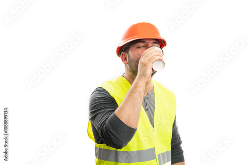 Constructor man sipping coffee from paper cup as morning concept