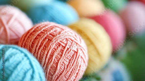 A row of colorful yarn balls on a wooden table. photo