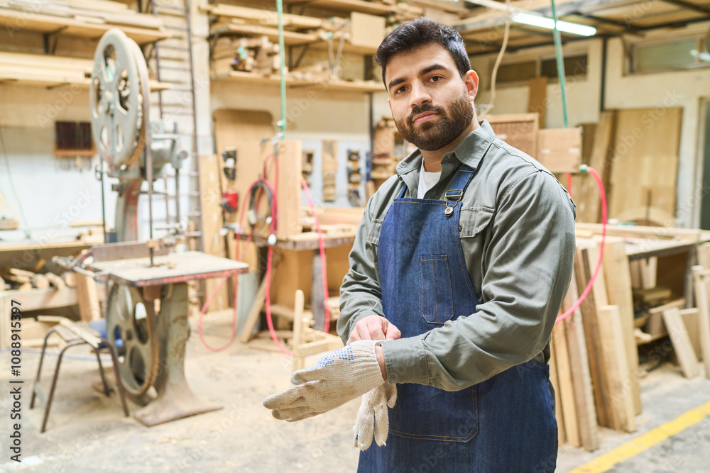 Confident worker in a lumberyard standing with crossed arms Confident worker in a lumberyard standing with crossed arms
