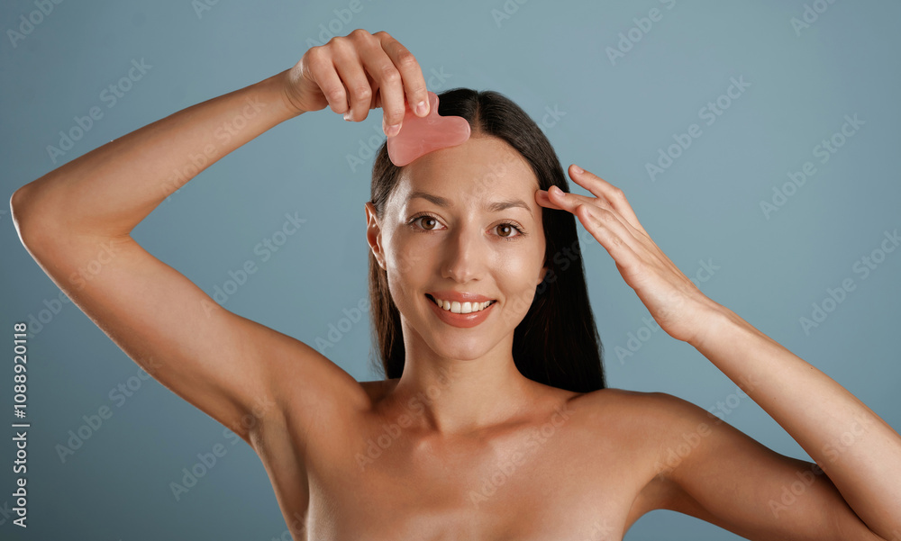 Patch for the face skin. Young woman is in the studio against background Patch for the face skin. Young woman is in the studio against background