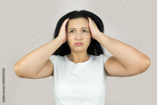 confused woman holding her head with her hands